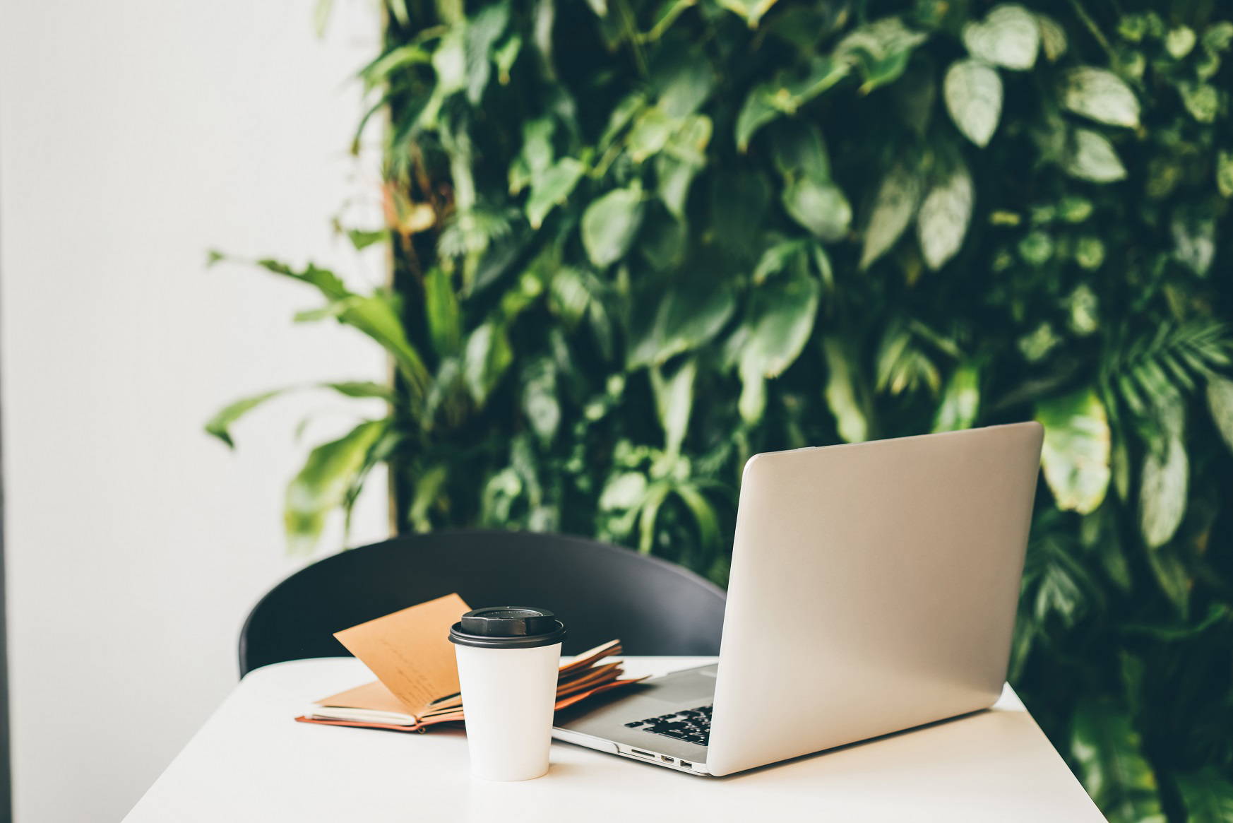 laptop with cup of coffee and notepad with pen